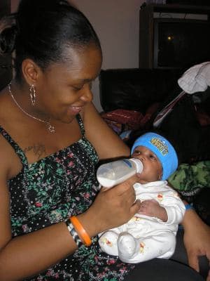 A mother holding her baby